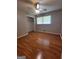 Neutral bedroom featuring wood-look floors, ceiling fan, a closet and a window with blinds at 4157 Cedar Valley Ln, Conley, GA 30288