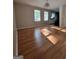 Sun-filled dining room featuring hard wood floors and view to kitchen at 4157 Cedar Valley Ln, Conley, GA 30288
