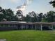 Charming brick ranch with a long carport and solar panels on roof at 4157 Cedar Valley Ln, Conley, GA 30288