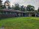 Traditional brick home with solar panels and a spacious front yard at 4157 Cedar Valley Ln, Conley, GA 30288