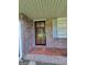Close-up view of a security screen door and patterned tile on the front porch of a brick home at 4157 Cedar Valley Ln, Conley, GA 30288