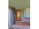 Inviting front entryway with a charming wooden door, secure screen, and patterned tile at 4157 Cedar Valley Ln, Conley, GA 30288