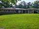 Charming brick home with a well-maintained lawn, solar panels, and a convenient carport at 4157 Cedar Valley Ln, Conley, GA 30288