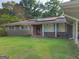 Attractive brick house with solar panels and a manicured lawn creating curb appeal at 4157 Cedar Valley Ln, Conley, GA 30288