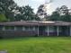 Cozy brick house featuring solar panels, light blue shutters, and a lush green lawn at 4157 Cedar Valley Ln, Conley, GA 30288