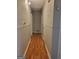 A hallway with hardwood floors with doors leading to other rooms at 4157 Cedar Valley Ln, Conley, GA 30288