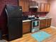 Kitchen featuring stainless steel appliances and warm wooden cabinets at 4157 Cedar Valley Ln, Conley, GA 30288