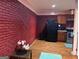 Kitchen with brick wall, wooden cabinetry and black appliances at 4157 Cedar Valley Ln, Conley, GA 30288