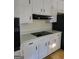 A kitchen featuring bright cabinets and a black range hood at 4157 Cedar Valley Ln, Conley, GA 30288