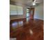 Sunlit living room featuring gleaming hardwood floors, neutral walls, and front door at 4157 Cedar Valley Ln, Conley, GA 30288