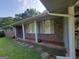Charming brick home featuring a covered porch with stone accents and columns at 4157 Cedar Valley Ln, Conley, GA 30288