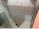 Tiled shower with a glass door and pebble flooring at 4157 Cedar Valley Ln, Conley, GA 30288