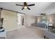 This bedroom features a fan, ensuite access, neutral walls, carpet, and a large window with a scenic view at 3222 Bay View Dr, Jonesboro, GA 30236