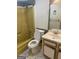 Bathroom features a tub, toilet, and vanity with outdated fixtures and tile flooring at 1308 Camelot Dr, South Fulton, GA 30349