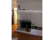 Cozy living room fireplace with white mantle, hearth, and wood laminate floor at 1308 Camelot Dr, South Fulton, GA 30349