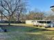 Spacious backyard shows mobile home and single-Gathering home at 225 Bell St, Covington, GA 30016