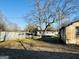 View of a backyard with mobile homes, sheds and sparse grass at 225 Bell St, Covington, GA 30016