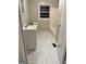 This is a bathroom with white marbled tile, tub, toilet and white vanity at 225 Bell St, Covington, GA 30016