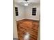 Bedroom with hardwood floors, neutral walls and ceiling fan with lighting fixture at 225 Bell St, Covington, GA 30016