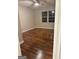 Bedroom with two windows, hardwood floors, ceiling fan and neutral walls at 225 Bell St, Covington, GA 30016
