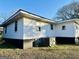 Rear of single story home shows painted concrete foundation and HVAC unit at 225 Bell St, Covington, GA 30016