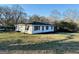 Quaint single-story home with white siding and a well-maintained yard at 225 Bell St, Covington, GA 30016