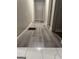 Hallway featuring gray, faux-wood flooring, neutral walls and white trim at 225 Bell St, Covington, GA 30016