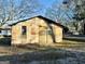 An exterior shot of an older shed with peeling paint and weathered siding at 225 Bell St, Covington, GA 30016