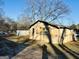 Exterior view of a shed with damaged siding and bare trees at 225 Bell St, Covington, GA 30016