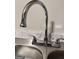Close-up of a stainless steel kitchen sink with a chrome, high-arc faucet at 225 Bell St, Covington, GA 30016