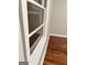 A close-up of a window with white trim and hardwood flooring underneath at 225 Bell St, Covington, GA 30016