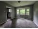 A well-lit dining area featuring large windows and updated flooring at 6679 Cameron Rd, Morrow, GA 30260