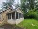 An enclosed sunroom addition with stone accents on an exterior view at 6679 Cameron Rd, Morrow, GA 30260