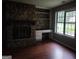 Cozy living room featuring a stone fireplace and built-in shelving at 6679 Cameron Rd, Morrow, GA 30260