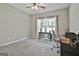 Bright bedroom features neutral walls, carpet, ceiling fan, and a window offering natural light at 211 Beavers Rd, Grantville, GA 30220