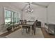 Bright dining area featuring a farmhouse-style table, modern chandelier, and shiplap accent wall at 211 Beavers Rd, Grantville, GA 30220