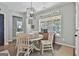 Cozy dining room with hardwood floors, updated lighting, and a view of the backyard through the window at 211 Beavers Rd, Grantville, GA 30220