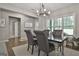 Dining room with hardwood floors, modern lighting fixture, and large window with natural light at 211 Beavers Rd, Grantville, GA 30220