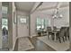 Formal dining room features a chandelier, natural light, and an elegant table set for a meal at 211 Beavers Rd, Grantville, GA 30220