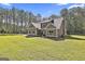 Green lawn surrounds a home with an attached garage, mature trees at 211 Beavers Rd, Grantville, GA 30220