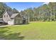 Expansive lawn and a home with an attached garage, surrounded by mature trees at 211 Beavers Rd, Grantville, GA 30220