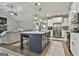 Open-concept kitchen features a center island with seating, stainless steel appliances, and modern finishes at 211 Beavers Rd, Grantville, GA 30220