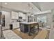 Eat-in kitchen with stainless appliances, white cabinets, center island with seating, and hardwood floors at 211 Beavers Rd, Grantville, GA 30220
