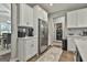 Modern kitchen features stainless steel appliances, white cabinets, and an adjacent laundry area at 211 Beavers Rd, Grantville, GA 30220