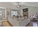 Bright living room featuring a vaulted ceiling, large stone fireplace, and comfortable seating at 211 Beavers Rd, Grantville, GA 30220