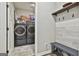 Spacious mud room features a bench, coat hooks, and a convenient washer and dryer set at 211 Beavers Rd, Grantville, GA 30220