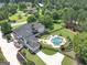 Aerial view of a grand estate showcasing a pool, and a long driveway at 30 Dorset Ct, Sharpsburg, GA 30277