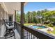 Back porch overlooking a stunning pool, hot tub, and landscaped backyard, creating an outdoor oasis at 30 Dorset Ct, Sharpsburg, GA 30277
