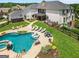 Aerial view of a large backyard featuring a pool with spa, lounge chairs, landscaping, and an outdoor seating area at 30 Dorset Ct, Sharpsburg, GA 30277