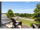 Private balcony with wooded view and wrought-iron railing at 30 Dorset Ct, Sharpsburg, GA 30277